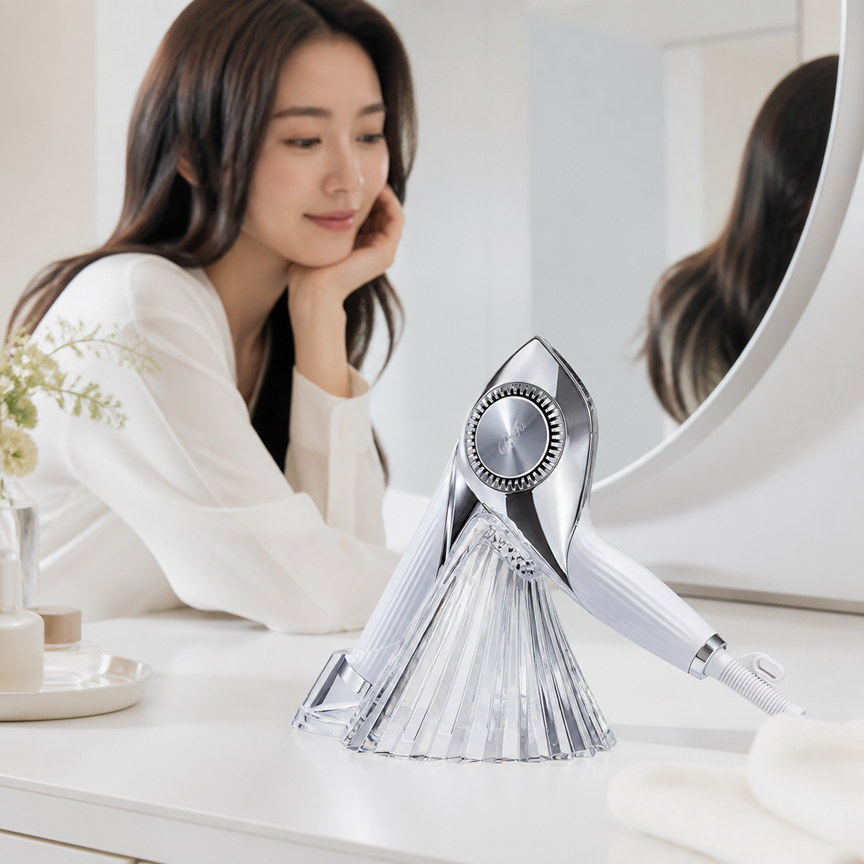 ReFa BEAUTECH DRYER BX placed in a clear faceted acrylic stand on a vanity table
