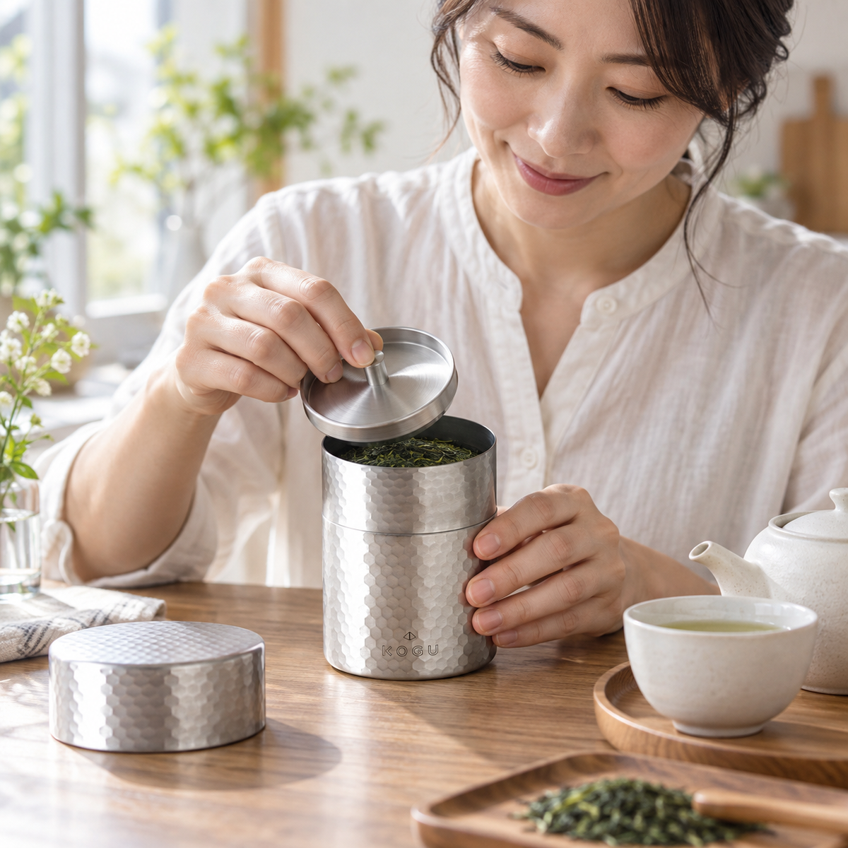 Japanese woman preparing tea with Chākōgu 40620 tea canister