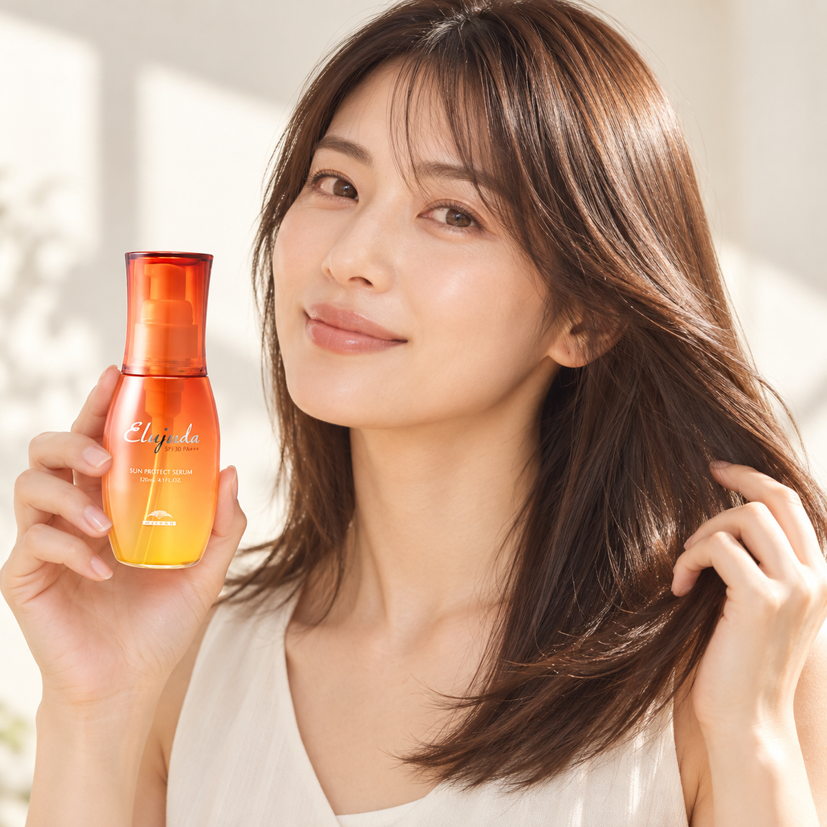 Japanese model holding Milbon Elujuda Sun Protect Serum