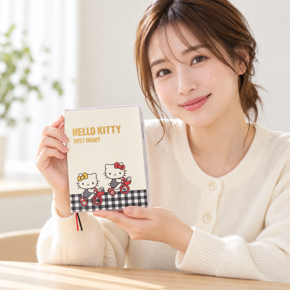 Original lifestyle image of an adult Japanese woman holding Hello Kitty B6 Diary 2027
