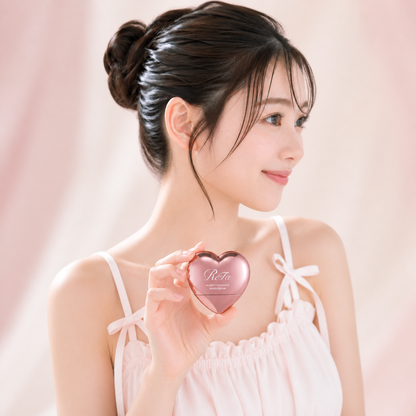 Japanese model naturally holding ReFa Heart Fragrance Hand Cream in rose gold