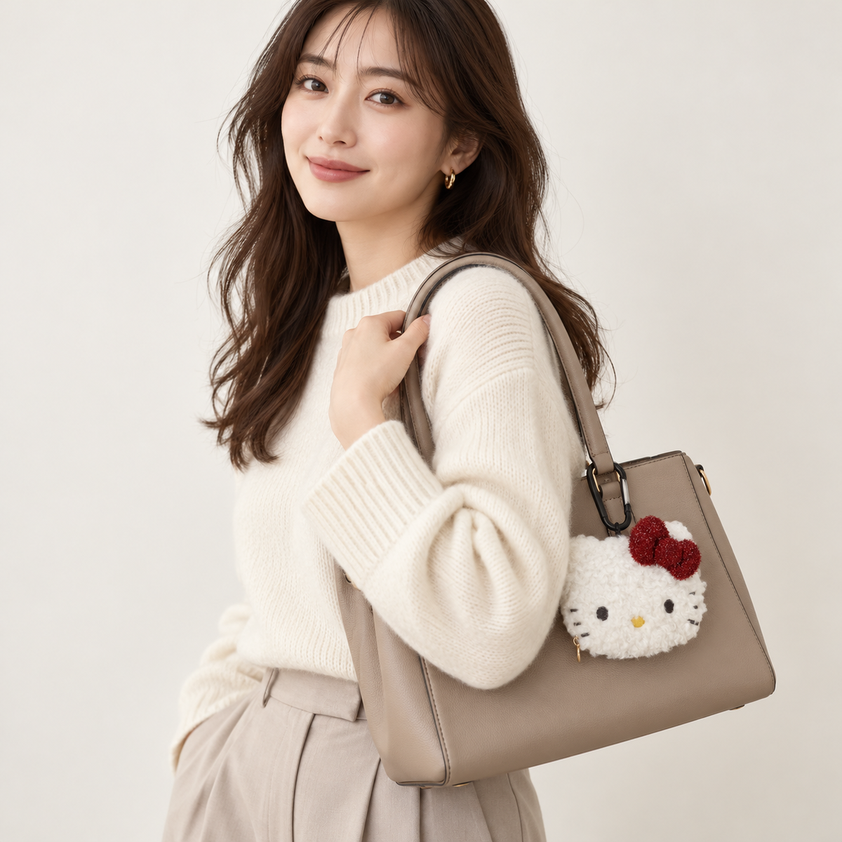 Styling illustration: Hello Kitty face pouch attached to a handbag; bag not included