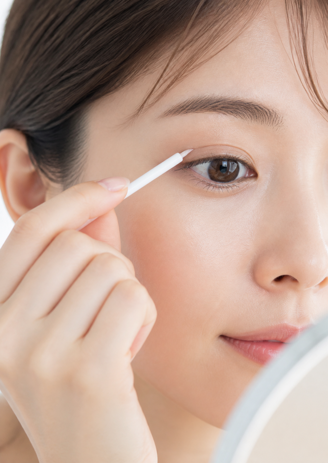 Adult woman applying ORISHIKI eyelid skin film