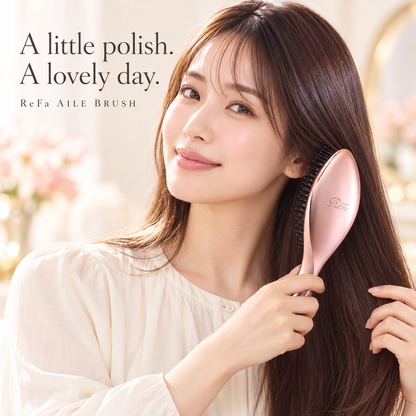 Japanese model brushing dry hair with ReFa AILE BRUSH Rose Gold - illustrative image