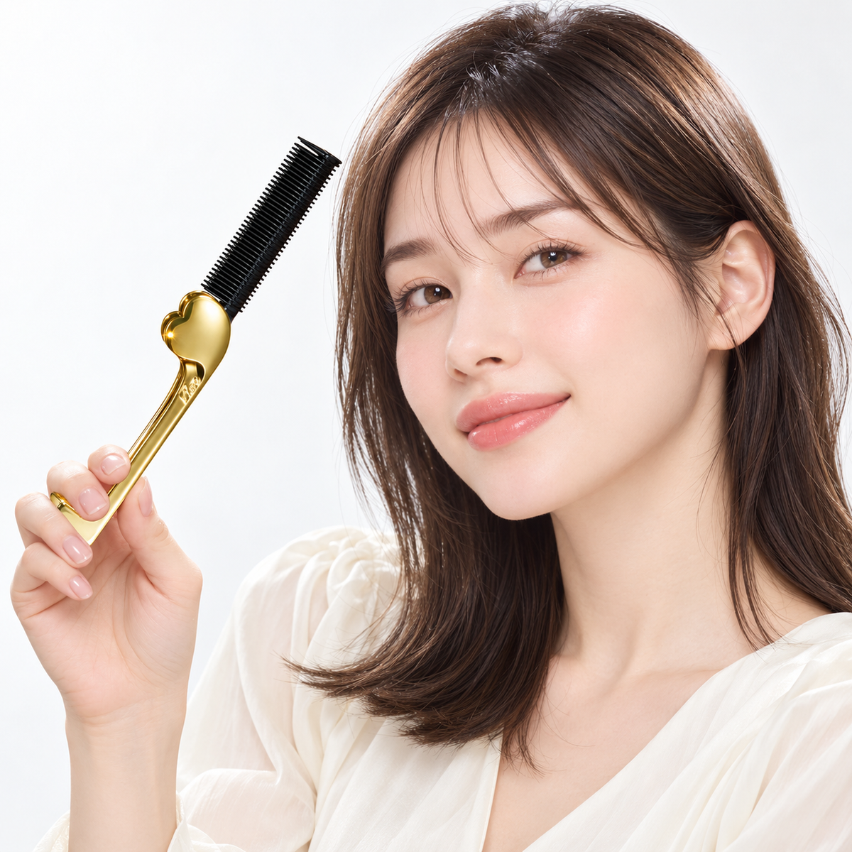 ReFa HEART COMB IRON Aira Japanese model holding the open gold comb