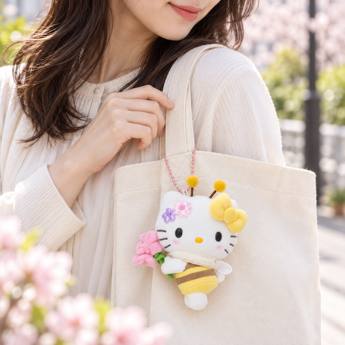Hello Kitty bee mascot holder on a cream tote