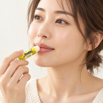 Japanese model applying Savex YUZU lip balm, illustrative image