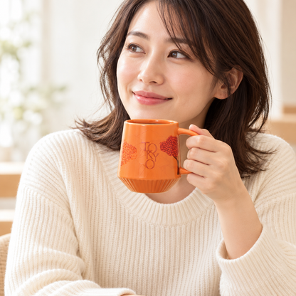 Orange pleats mug at natural scale in use