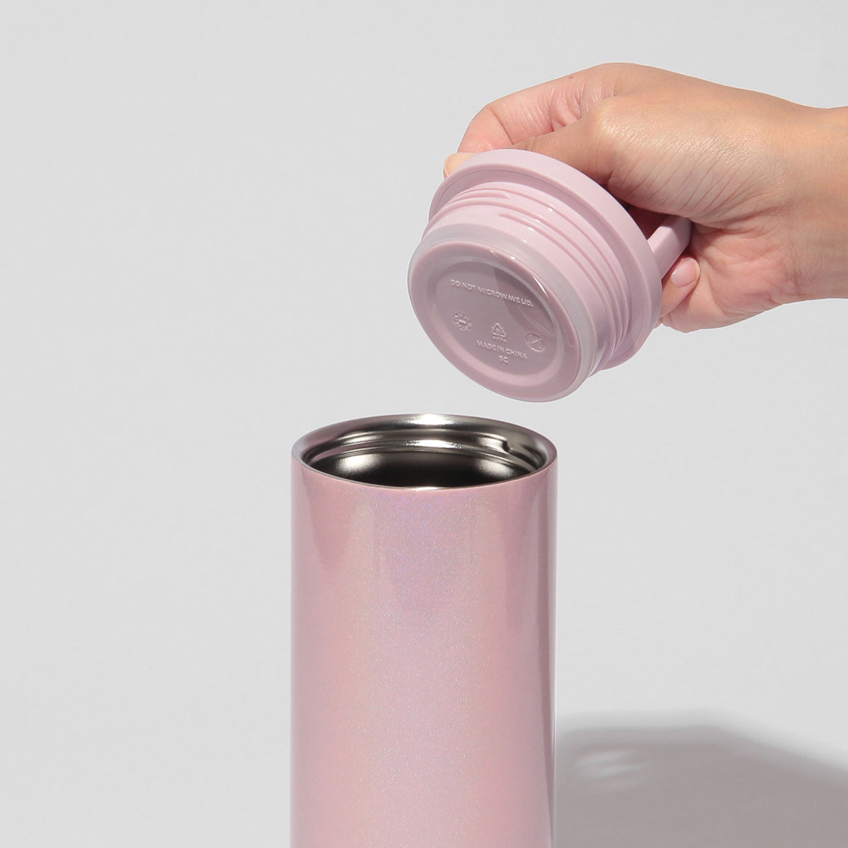 Starbucks Reserve pink stainless steel bottle with lid removed, showing the wide opening