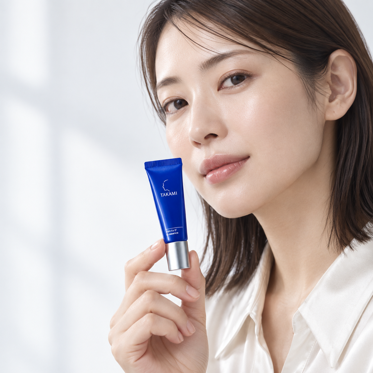 AI-generated model holding TAKAMI Lip Essence blue tube